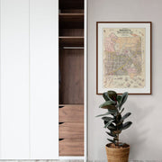 Framed historical map print of Wangaratta, Victoria hung on the wall beside a wardrobe in a softly lit bedroom