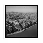 Vintage 1950s aerial photo of the Wellington coastline with waves, shoreline and residential areas.