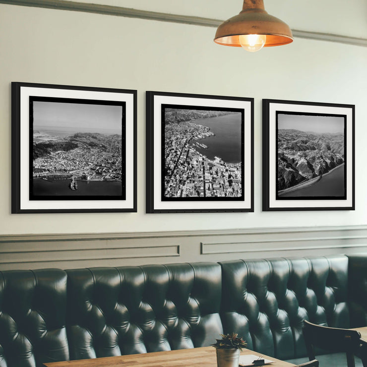 Aerial black-and-white 1950s photographs of Wellington City showing harbour, hills, coastline and urban streets.